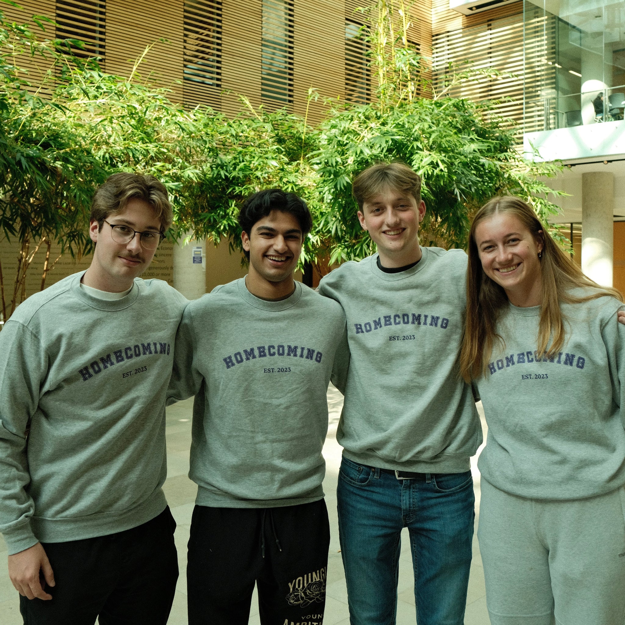 Image of four students wearing Lazaridis Homecoming merchandise
